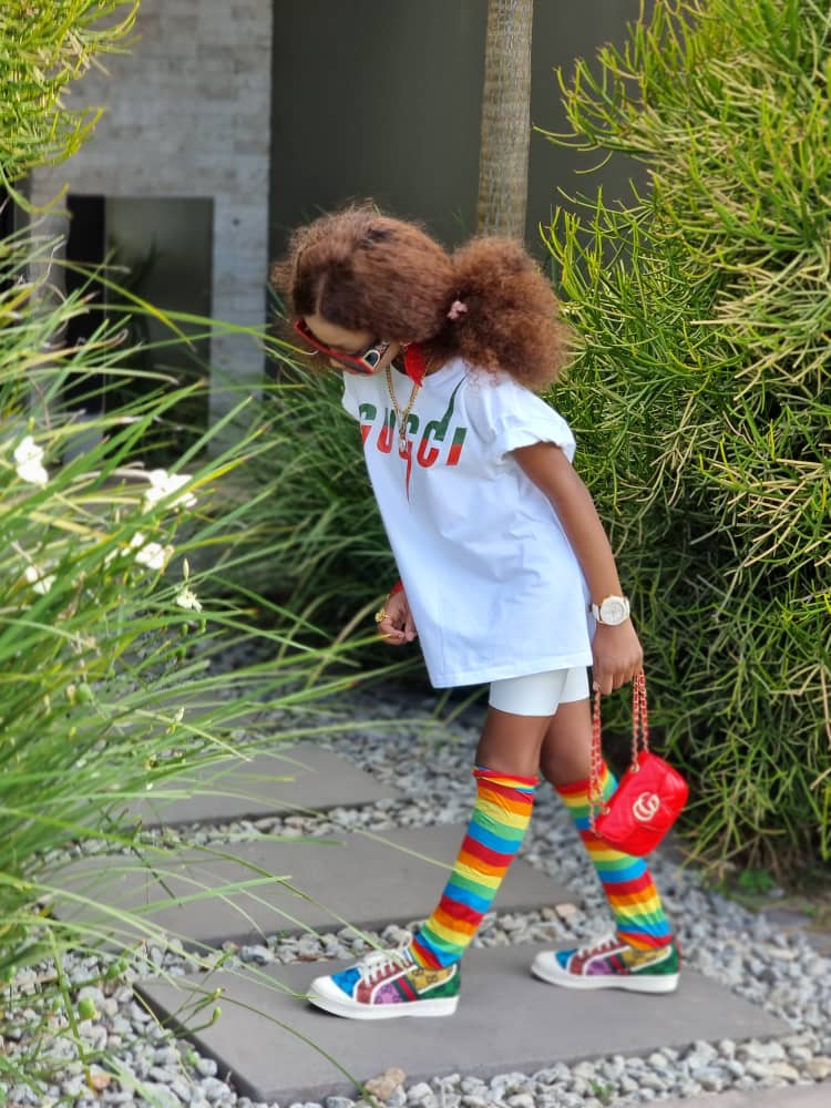Girl wearing White round neck t-shirt with green and red Gucci text logo