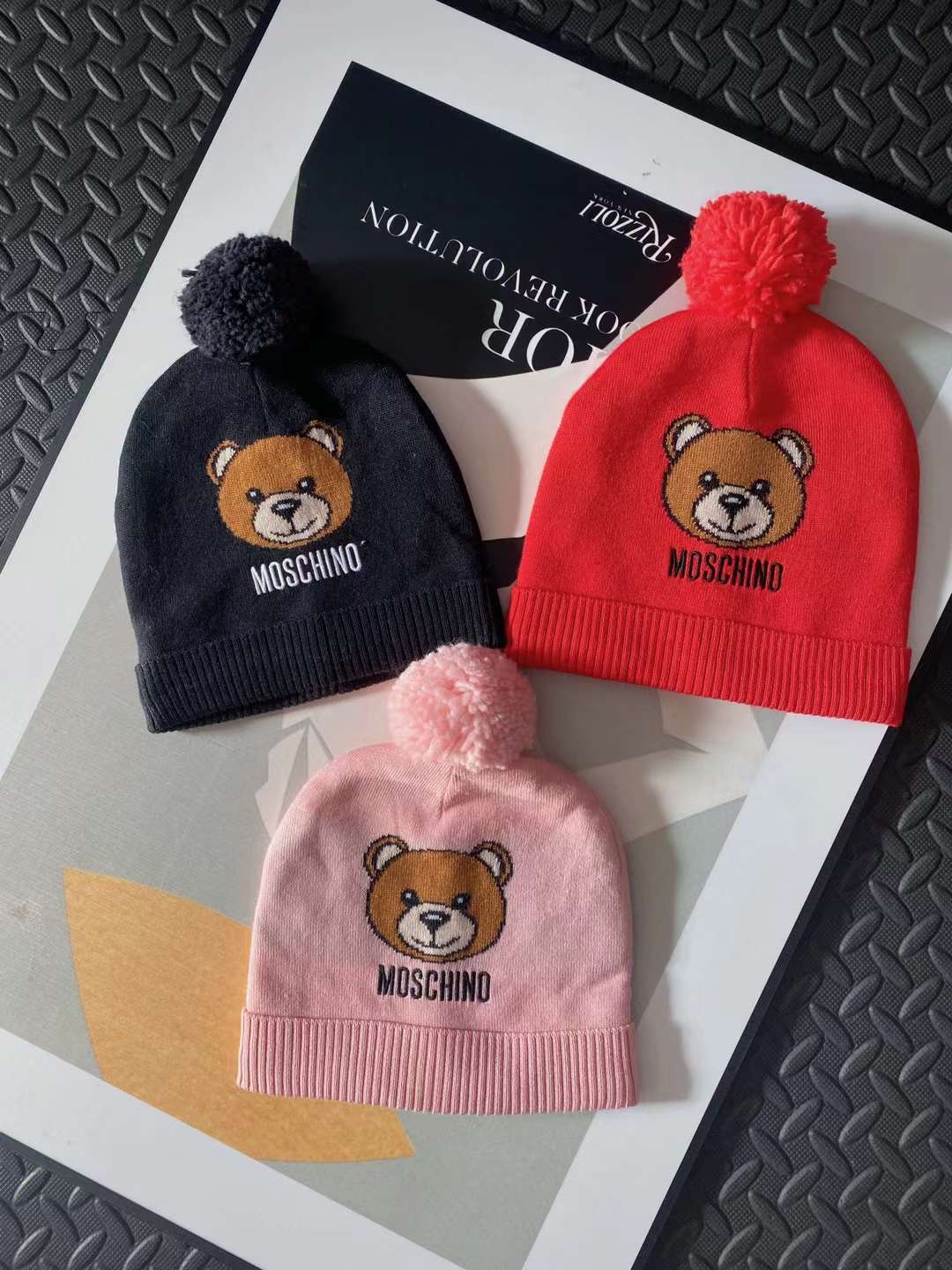 Black, red and pink winter bennie with teddy bear head and Moschino text logo
